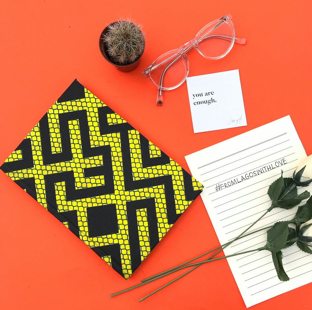 Notebook and coffee on a wooden desk for personal reflection