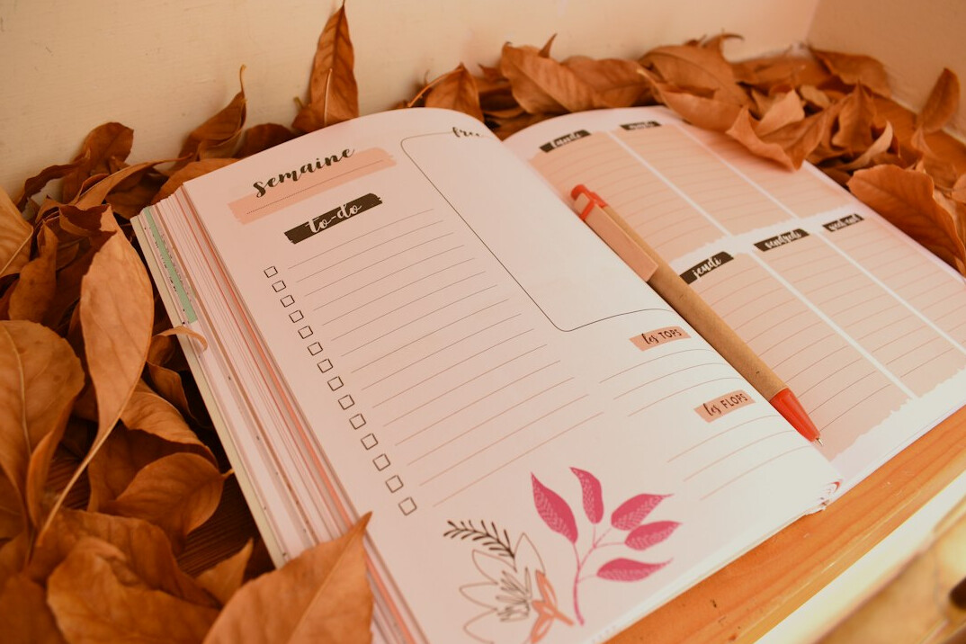 Open planner with a pen on a table for daily habits