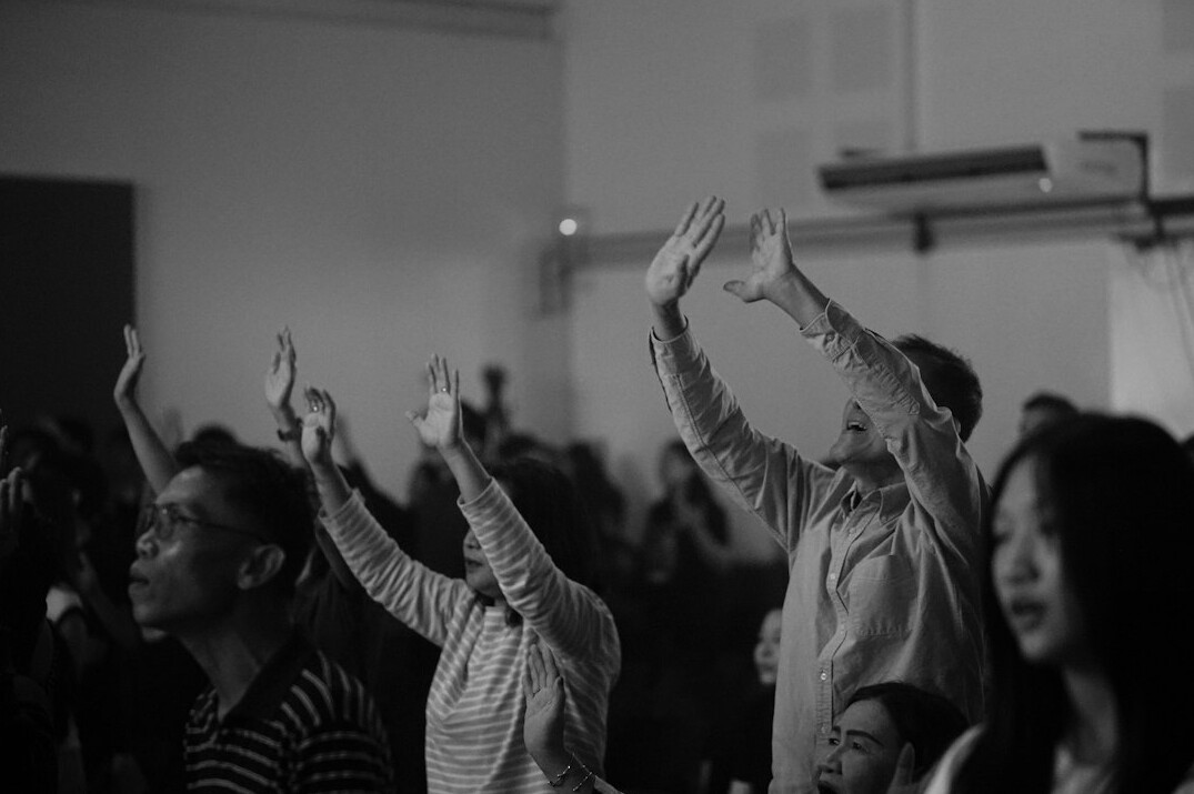 People gesturing during a group workshop discussion